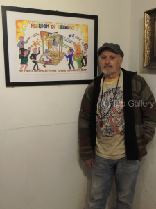 Toby Zoates with his painting, "Freedom to Discriminate"